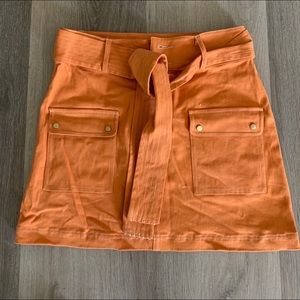 Neon orange skirt w tie are matching jacket